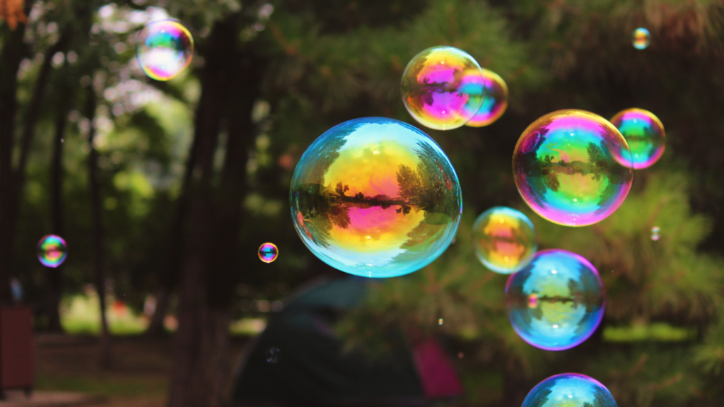 Ordinary Weirdness Rainbow Bubbles In The Park by Lydia89 from pixabay (Free use via Canva)